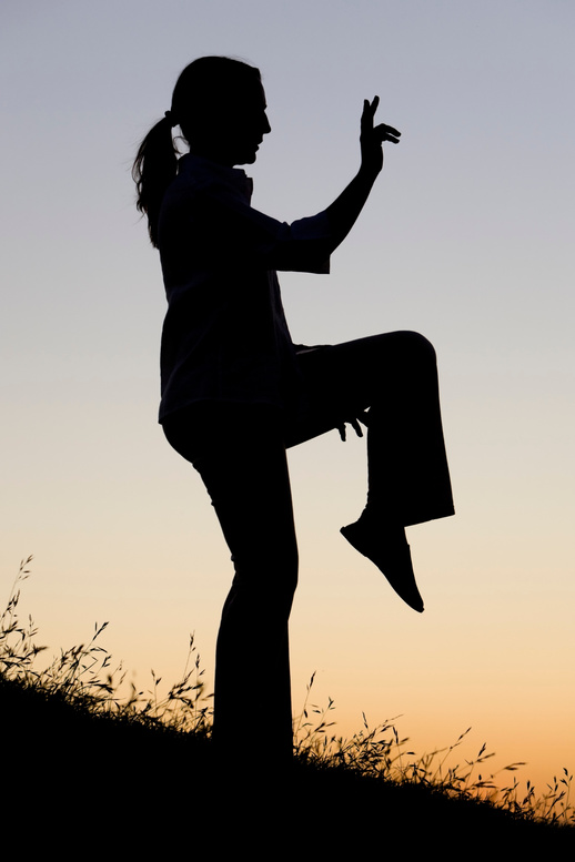 Tai chi figure at sunset